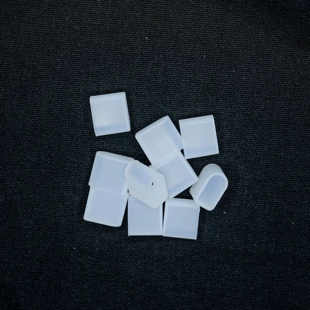 White sugar cubes scattered on a surface with 8x16 End Cap for flexible neon flex neon installation