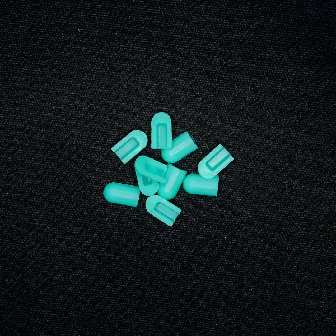 Scattered turquoise plastic valve stem caps for coloured end caps in Mars Green flexible neon