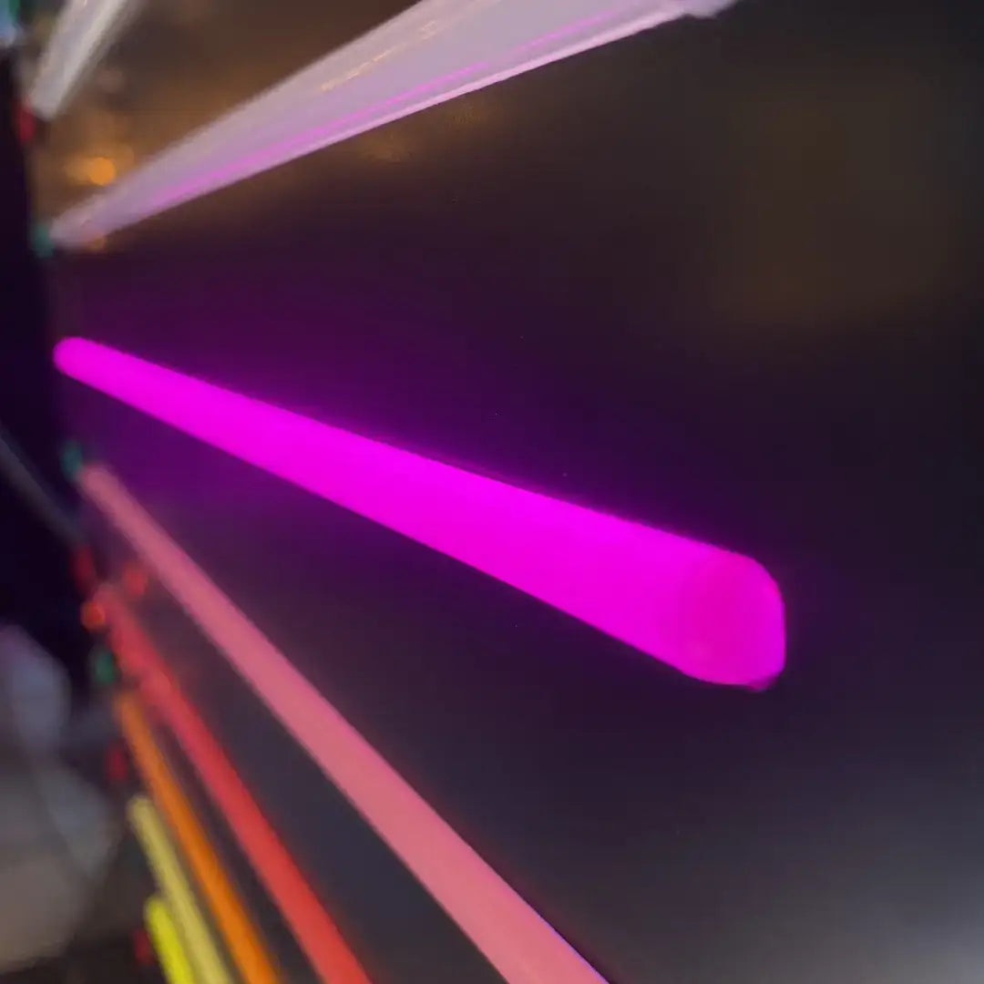 Bright pink and orange neon light streaks radiating outward on coloured end caps for 8x16 flex neon installation