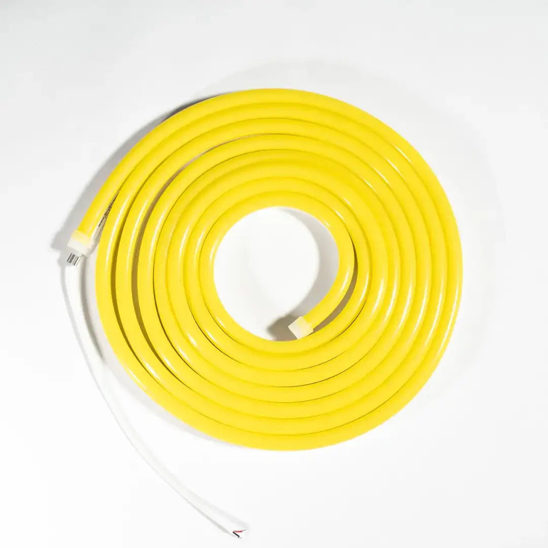 Yellow coiled garden hose with white connectors, ideal for architectural strips and horizontal bending