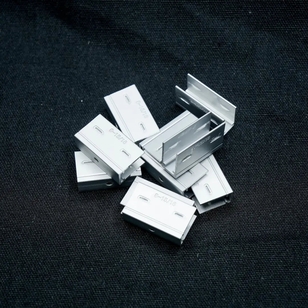 Metal staples scattered in a loose pile for 6x12 aluminium mount clip product display