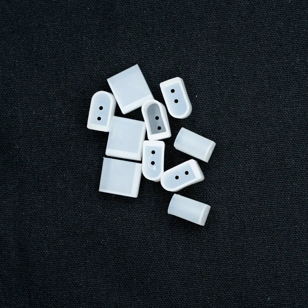 White rectangular buttons scattered on surface for 6x12 Flex Neon installation and flexible neon projects