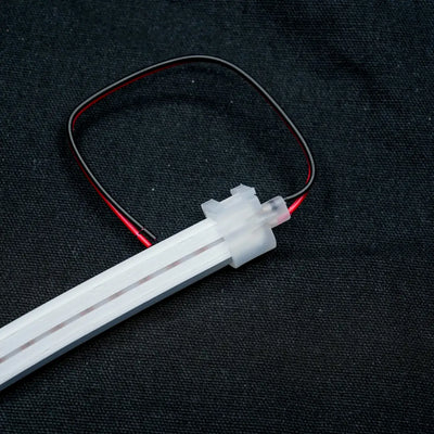 White LED strip with red and black wiring attached to an 8x16 Quick Connector for effortless linking