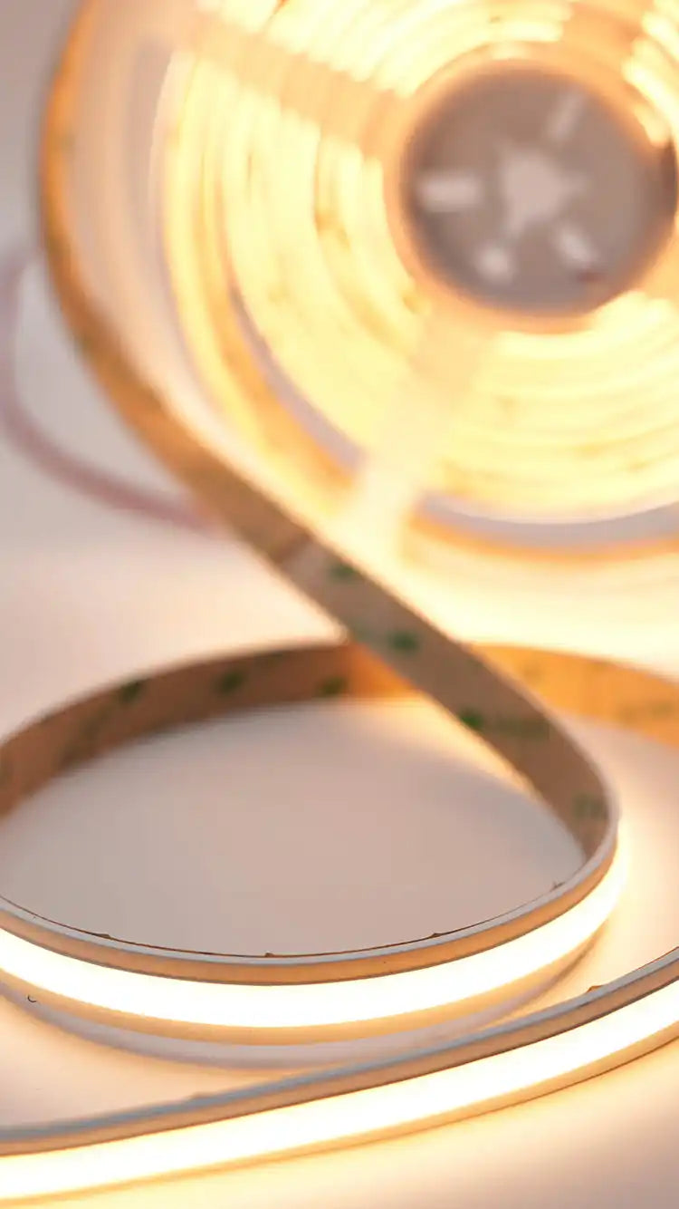 Coiled strip of metallic or copper-colored tape with a reflective surface.