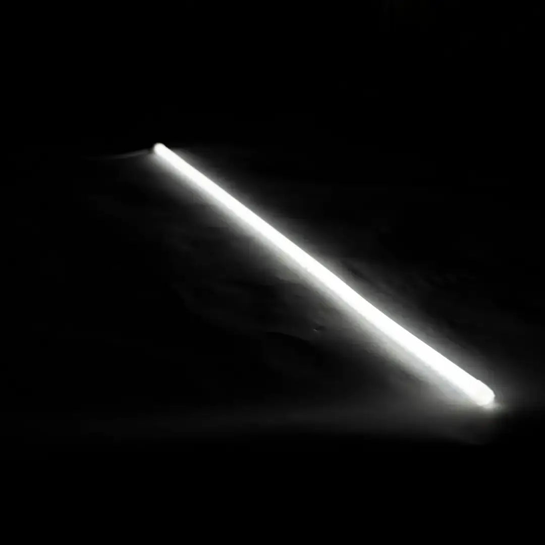 Glowing white flex neon strip for architectural lighting with vertical bending against dark background
