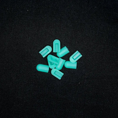 Scattered turquoise coloured end caps for 8x16 flex neon tires in Mars Green color