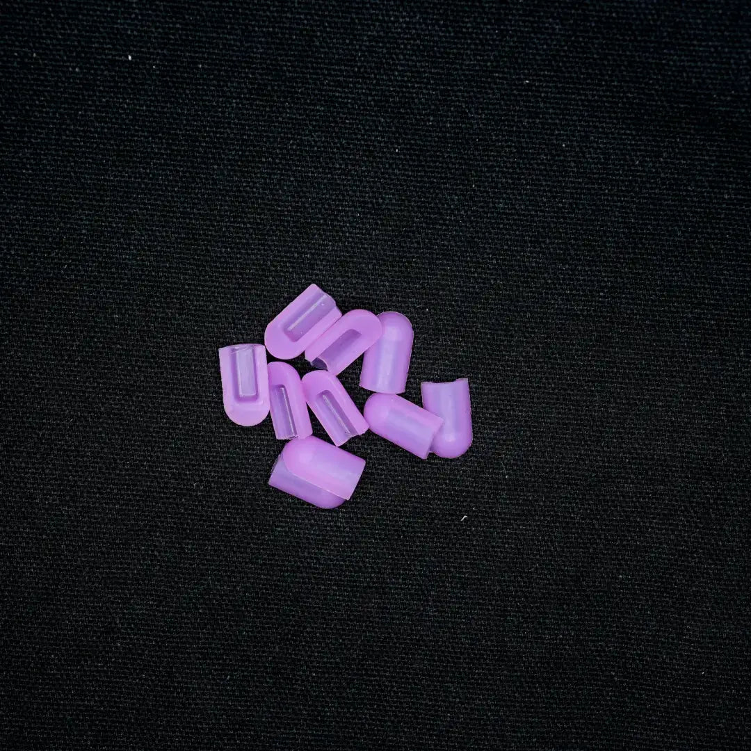 Purple plastic coloured end caps for 8x16 flex neon installation, scattered together