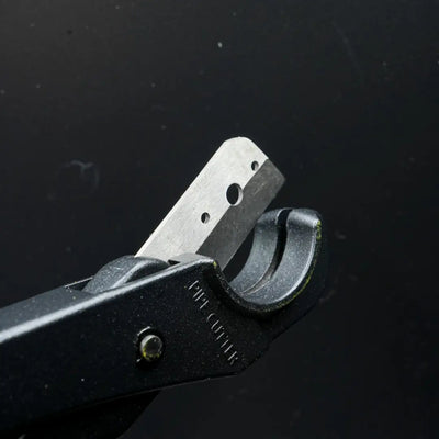 Metal hand-operated hole punch with flexible neon cutters and premium Teflon blade