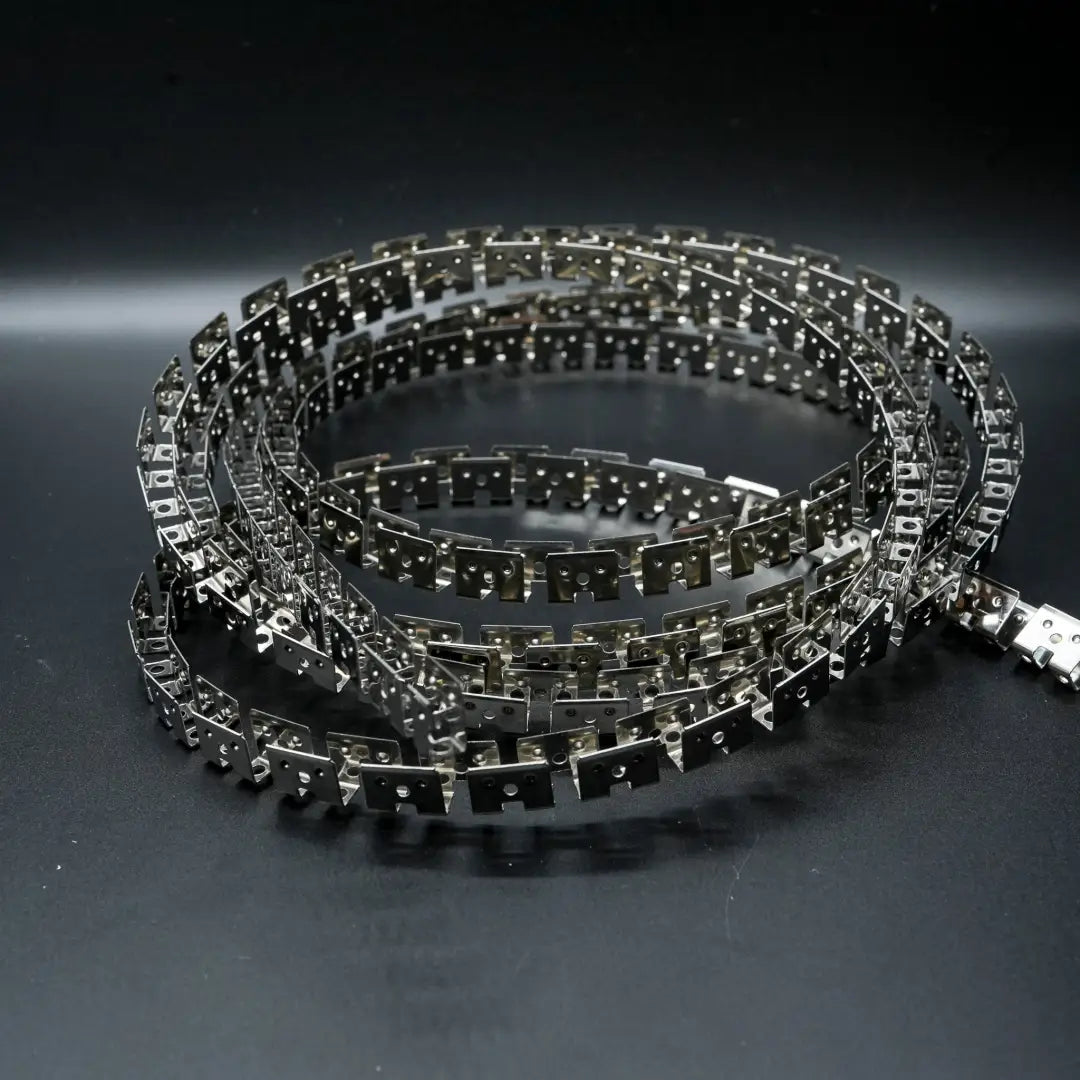 Coiled metallic bicycle or motorcycle chain with shiny silver finish for flexible SS mounting