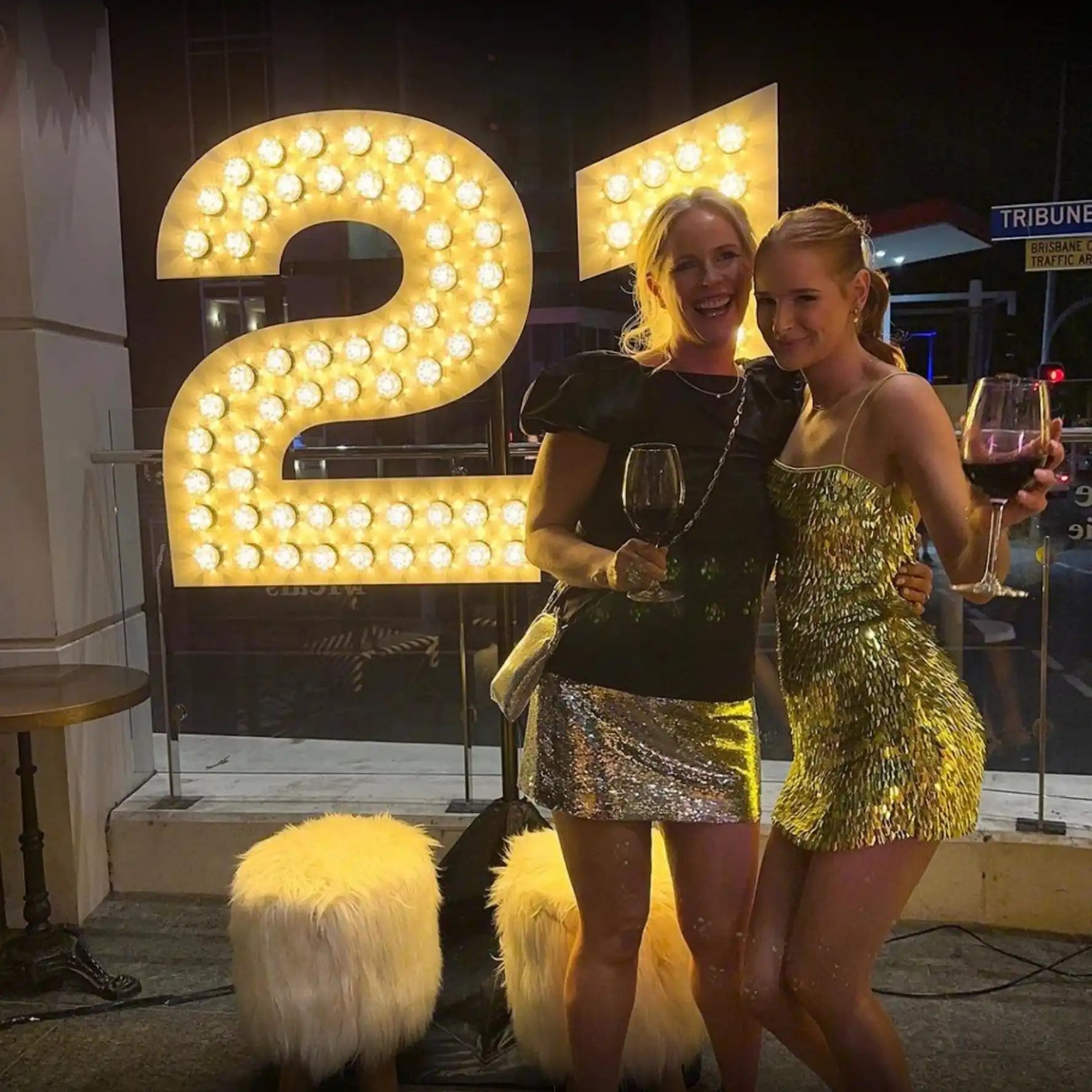 Illuminated number ’21’’ with light bulbs mounted on it.
