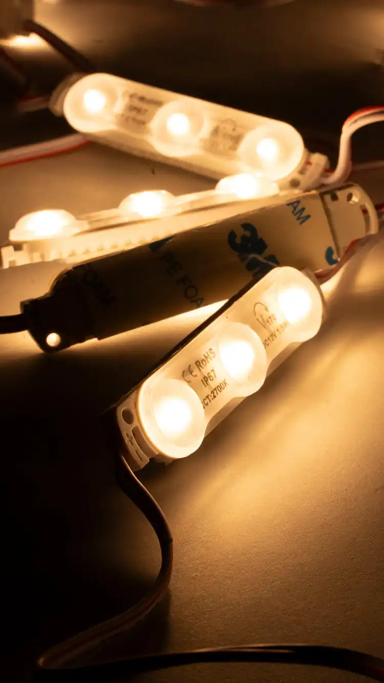 LED light modules with multiple warm glowing bulbs connected by wiring.