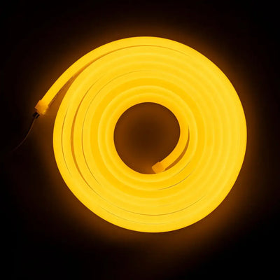 Glowing yellow flexible neon LED strip coiled in a circular shape for architectural strips