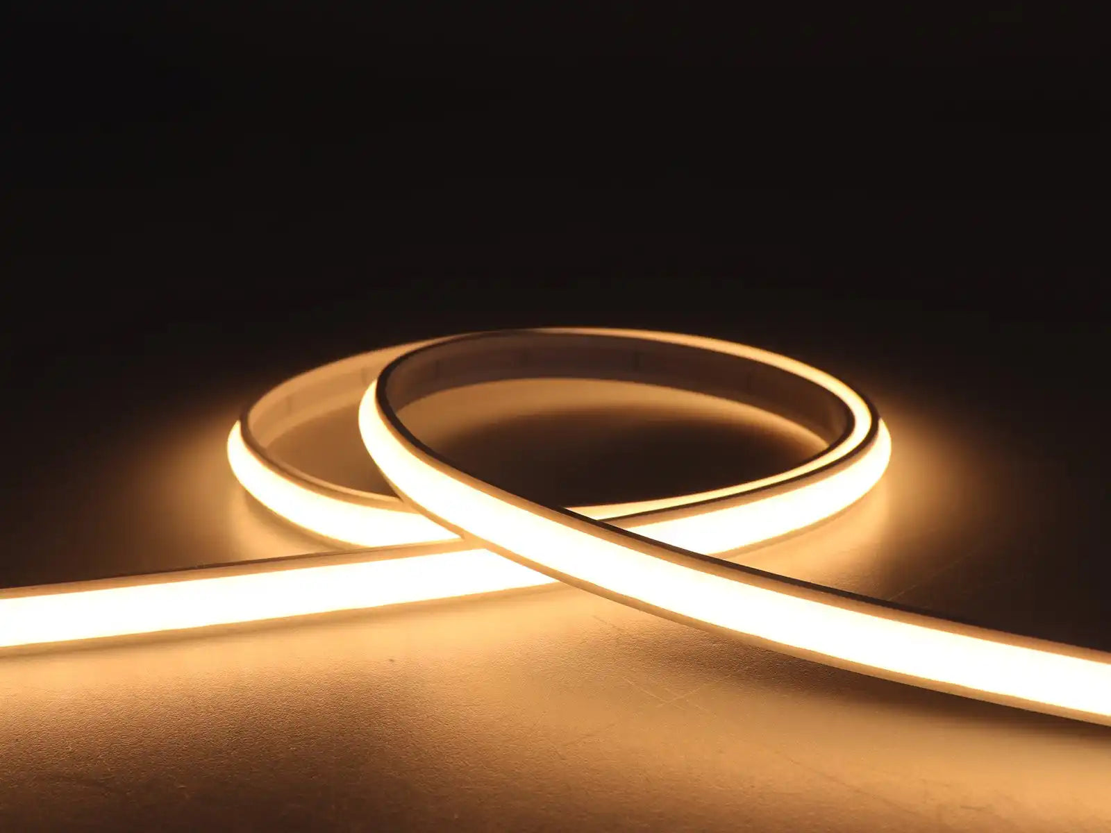 Glowing LED strip light curved into a graceful loop.