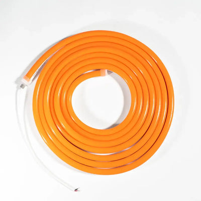Coiled orange electrical extension cord with white ends for neon LED strip and architectural strips
