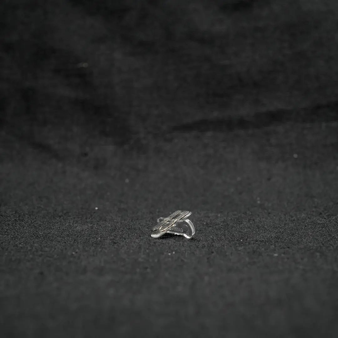 Silver ring resting on surface with 10x13x22 snap connectors in landscape series flexible design